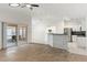 Open floor plan with wood flooring, kitchen, and a view to a screened lanai at 4087 Clock Tower Dr, Port Orange, FL 32129
