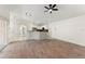 Open floor plan with wood flooring showcases the kitchen with breakfast bar seating at 4087 Clock Tower Dr, Port Orange, FL 32129
