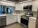 Modern kitchen features stainless steel appliances and ample white cabinetry at 459 Hamptoncrest Cir # 203, Lake Mary, FL 32746