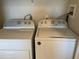 Laundry room area featuring white Whirlpool washer and dryer units at 459 Hamptoncrest Cir # 203, Lake Mary, FL 32746