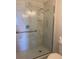 The marble-tiled shower stall features a glass door, rainfall shower head and grab bar at 459 Hamptoncrest Cir # 203, Lake Mary, FL 32746