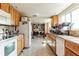 Functional kitchen features tile floors, wooden cabinets, and an adjacent laundry area for added convenience at 4616 Tower Pine Rd # 4616, Orlando, FL 32839