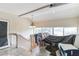 An upper loft provides extra flexible space with natural light from surrounding windows and stairs at 4616 Tower Pine Rd # 4616, Orlando, FL 32839