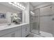 Modern bathroom featuring double vanity, a glass-enclosed shower, and stylish fixtures, offering a luxurious feel at 4827 Lacewing Dr, Winter Garden, FL 34787