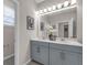 Elegant bathroom featuring a double vanity, a large mirror, and modern fixtures, creating a spa-like experience at 4827 Lacewing Dr, Winter Garden, FL 34787