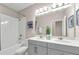 Bright bathroom features double vanity, shower over tub and neutral tones at 4827 Lacewing Dr, Winter Garden, FL 34787