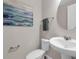 Well-lit bathroom with a pedestal sink, modern fixtures, and neutral decor at 4827 Lacewing Dr, Winter Garden, FL 34787