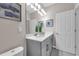 Bright bathroom features a single vanity, white walls and tile flooring at 4827 Lacewing Dr, Winter Garden, FL 34787