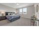 Bright bedroom boasts a comfortable bed, large windows, and elegant decor, creating a serene and inviting atmosphere at 4827 Lacewing Dr, Winter Garden, FL 34787