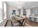 Dining room with rustic table, upholstered chairs, and view into the kitchen at 4827 Lacewing Dr, Winter Garden, FL 34787