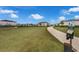 A spacious dog park with green space, walking paths, and waste disposal stations at 4827 Lacewing Dr, Winter Garden, FL 34787