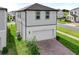 Two-story home with a two-car garage, brick driveway, and well-maintained landscaping at 4827 Lacewing Dr, Winter Garden, FL 34787