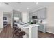 Stylish kitchen with stainless steel appliances, gray cabinets, and white quartz countertops at 4827 Lacewing Dr, Winter Garden, FL 34787