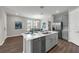 Bright kitchen with a large island, stainless steel appliances, and open dining area, perfect for modern living at 4827 Lacewing Dr, Winter Garden, FL 34787