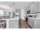 Modern kitchen featuring gray cabinets, stainless steel appliances, and a breakfast bar at 4827 Lacewing Dr, Winter Garden, FL 34787