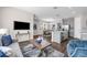 Open concept living space flowing to the dining room and modern kitchen at 4827 Lacewing Dr, Winter Garden, FL 34787