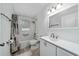 Bathroom with a shower/tub combo, marble tile, modern vanity, and updated fixtures at 5 Redwood Trace Run, Ocala, FL 34472