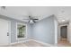 Cozy bedroom with a ceiling fan, modern flooring, and a large window offering a serene view and natural light at 5 Redwood Trace Run, Ocala, FL 34472