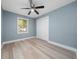 Bright bedroom featuring a ceiling fan, closet, and a window providing natural light, creating a comfortable and inviting space at 5 Redwood Trace Run, Ocala, FL 34472