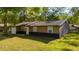 Front exterior featuring a single-car garage, neutral siding, and a simple front door at 5 Redwood Trace Run, Ocala, FL 34472