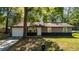 Charming single-story home with a well-maintained front lawn and attached garage at 5 Redwood Trace Run, Ocala, FL 34472
