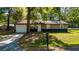 Charming single-story home with a manicured lawn, attached garage and stone accents enhancing its curb appeal at 5 Redwood Trace Run, Ocala, FL 34472