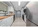 Modern kitchen featuring stainless steel appliances, butcher block countertops and bright white cabinetry, with stylish backsplash at 5 Redwood Trace Run, Ocala, FL 34472