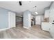 Open-concept kitchen flows into the living area, featuring stainless steel appliances and seamless flooring throughout at 5 Redwood Trace Run, Ocala, FL 34472