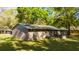 Rear exterior displaying a screened-in porch and classic architectural design at 5 Redwood Trace Run, Ocala, FL 34472
