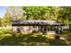 Back exterior of home featuring an enclosed patio for seamless indoor-outdoor living at 5 Redwood Trace Run, Ocala, FL 34472