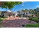 An expansive brick patio connects the house to outdoor seating areas and a fountain at 525 Sheridan Blvd, Orlando, FL 32804