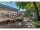 The home's idyllic backyard with a covered patio, brickwork, mature trees and lush, green landscaping at 525 Sheridan Blvd, Orlando, FL 32804