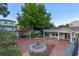 A backyard showcases a brick patio, mature trees, a fountain, and an outdoor dining area at 525 Sheridan Blvd, Orlando, FL 32804