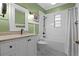 Bright bathroom featuring white subway tile, a modern vanity, and stylish black and white tile floors at 525 Sheridan Blvd, Orlando, FL 32804