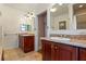 Bathroom featuring dual sinks with granite countertops and decorative tile flooring at 525 Sheridan Blvd, Orlando, FL 32804