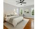 Cozy bedroom with a plush bed, natural light, and hardwood floors at 525 Sheridan Blvd, Orlando, FL 32804