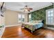Bright bedroom with hardwood floors, natural light and unique wallpaper feature wall at 525 Sheridan Blvd, Orlando, FL 32804