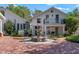 Landscaped courtyard features a tiered fountain, brick paving, and a charming white home with black accents at 525 Sheridan Blvd, Orlando, FL 32804