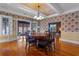 Dining room featuring hardwood floors, decorative wallpaper, and chandelier at 525 Sheridan Blvd, Orlando, FL 32804