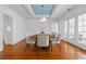 Bright dining room with hardwood floors, modern chairs, and views to the living room at 525 Sheridan Blvd, Orlando, FL 32804