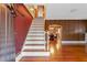 Elegant entryway with hardwood floors, staircase, and arched doorway leading to the dining room at 525 Sheridan Blvd, Orlando, FL 32804