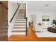 Bright entryway with hardwood floors, staircase, and open concept living and dining areas at 525 Sheridan Blvd, Orlando, FL 32804