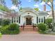 Charming home featuring a brick walkway, covered entry, white columns, and meticulous landscaping at 525 Sheridan Blvd, Orlando, FL 32804