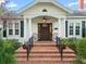 Charming home with an inviting front entrance featuring brick steps, classic columns, and stylish outdoor seating at 525 Sheridan Blvd, Orlando, FL 32804
