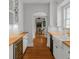 Bright white kitchen featuring wooden countertops and stainless steel wine fridge at 525 Sheridan Blvd, Orlando, FL 32804