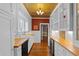 Traditional kitchen featuring white cabinets, wood countertops, and gold tin ceiling at 525 Sheridan Blvd, Orlando, FL 32804