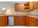 A charming kitchenette features wood cabinets, mini fridge, and tile countertop at 525 Sheridan Blvd, Orlando, FL 32804