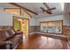 Open-concept living room with wood floors and view into the kitchen at 525 Sheridan Blvd, Orlando, FL 32804