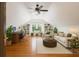 Bright living room features vaulted ceiling, built-in shelves, modern furniture, hardwood floors and many plants at 525 Sheridan Blvd, Orlando, FL 32804