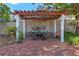 An outdoor space features a pergola-covered dining area with a swing at 525 Sheridan Blvd, Orlando, FL 32804